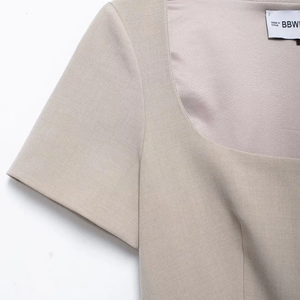Elegant beige short sleeve square neck blazer top with a tailored waist and woven texture