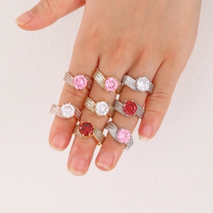 Close-up of fashion triple-row rings with large round zircon stones on a hand model