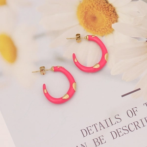 Chic pink enamel hoop earrings with gold teardrop accents on minimalist display card