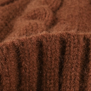 Close-up of brown jacquard knit hat showing thick plush fleece and ribbed texture
