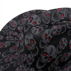 Detailed macro shot of gothic skull pattern with red glitter eyes on black fabric hat