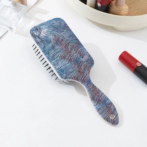 Close-up of blue and purple wood grain texture on the paddle hairbrush back