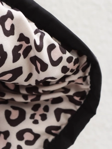 Close-up of leopard print quilted fabric detail in black, pink and beige cotton