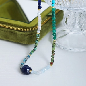Handmade beaded necklace with natural colorful agate stones and a dark blue center stone