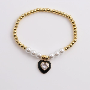 Elegant gold beaded bracelet with white pearls and black-edged heart zircon pendant
