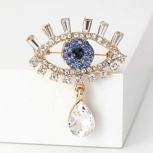 Luxury gold Evil Eye brooch with blue and white rhinestones and crystal teardrop