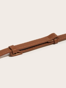 Detailed close-up of brown Saffiano leather belt texture with precise stitching work
