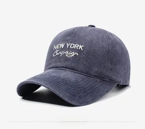Close-up of vintage washed navy denim baseball cap with New York embroidery detail