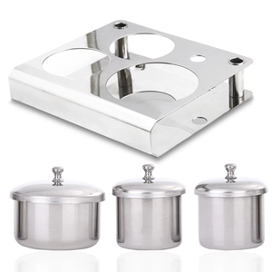 Close-up of three stainless steel nail art liquid cups with lids and rectangular base stand