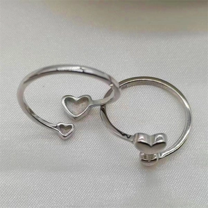 Detail of S925 sterling silver open ring featuring large and small double heart design