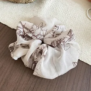 Vintage cream oversized fabric scrunchie with brown retro pattern on a wooden surface