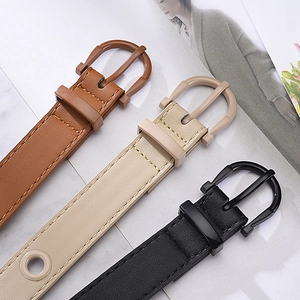 Three candy-colored faux leather eyelet belts in black, beige, and brown with metal buckles