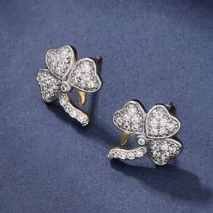 Micro-inlaid zircon clover earrings with silver and 14K gold tones on blue surface
