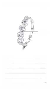 Macro shot of S925 silver ring featuring 4mm heart-shaped zircon stones and engravings