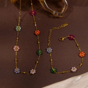 Close-up of bohemian colorful flower beaded stainless steel necklace and bracelet set