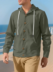 Detail of army green cotton linen hooded shirt jacket with wooden buttons and drawstrings