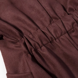 Macro shot of elastic cinched waist and high-density stitching on faux suede jacket