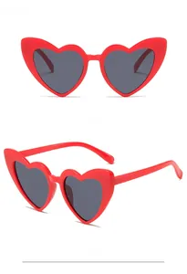 Front and side macro views of red heart-shaped sunglasses with dark lenses