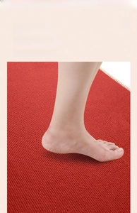 Close-up of red striped wedding floor mat with soft velvet texture and non-slip surface