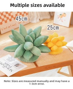 Detail showing plush succulent pillows in green and yellow on a wooden table surface