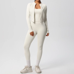 Detailed close-up of beige 3-piece yoga set with zip-up jacket, camisole, and leggings