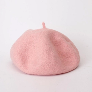 Close-up of pink wool beret showing fine knitted texture and soft fabric detail