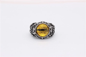 Macro shot of gothic bat ring with yellow dragon eye gemstone and scales texture