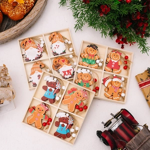 Flat lay of Christmas wooden ornaments with gingerbread men and gnomes on a white surface