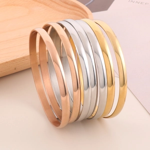 Minimalist polished stainless steel bangles in gold, rose gold and silver colors