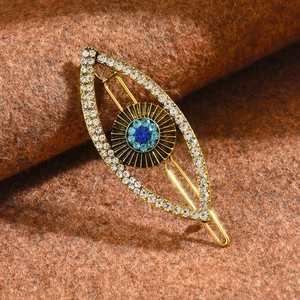 Punk Evil Eye hair clip with sparkling rhinestones and gold alloy frame on wool fabric