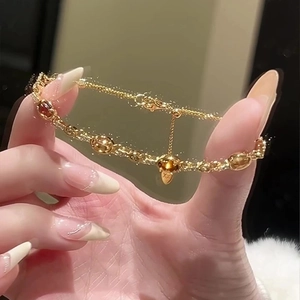 18k gold plated bracelet with amber resin stones and a delicate heart pendant