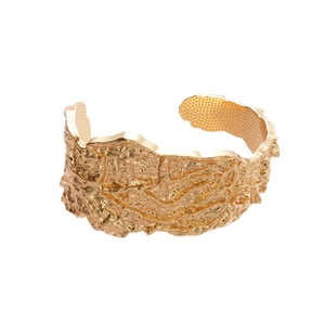 Irregular gold cuff bracelet with embossed lava texture in a wide minimalist open design