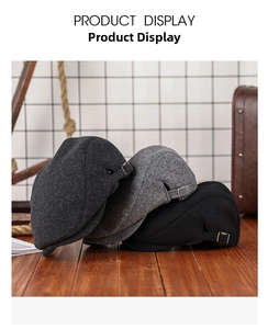 Close-up of thick wool newsboy caps in three colors with vintage metal side buckles