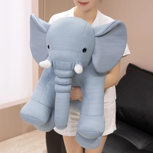 Soft light blue elephant plush toy with dotted texture, large ears and white tusks