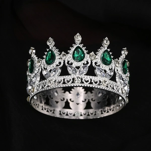Silver baroque crown with teardrop green emeralds and heart-shaped hollow patterns