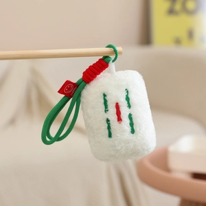 Detail of Mahjong tile plush keychain featuring red embroidery on soft white fabric