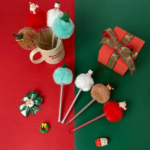 Cute Christmas pom-pom pens featuring Santa, Snowman, and Reindeer in a festive gift setup
