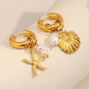 Detail of 18K gold-plated earrings featuring starfish shell and white pearl pendants