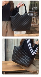 Detail of black quilted tote bag showing large capacity and elegant rhombus pattern