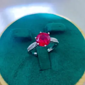 Detail view of a 2-carat red ruby ring with six-prong setting and side diamonds