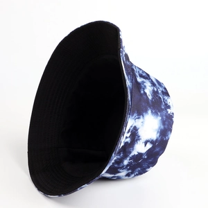 Detail view of tie-dye bucket hat with blue and white pattern and black lining