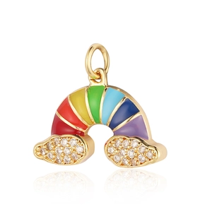 Macro detail of gold rainbow charm with colorful enamel and zircon-inlaid clouds
