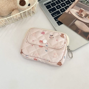 Detailed view of pink quilted card holder with cute cartoon floral patterns and snap pocket