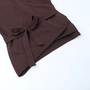Detail of dark brown ribbed knit set featuring adjustable waist tie and fine texture