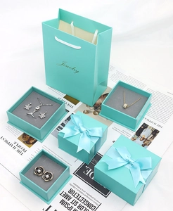 Elegant tiffany blue jewelry gift box set with silk bow and matching shopping bag
