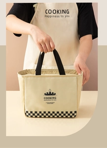 Close-up of cream insulated lunch bag with checkered pattern held by a person