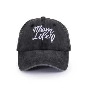 Close-up of white Mom Life embroidery and heart on a washed dark gray denim baseball cap