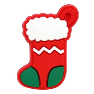 Close-up of a red and green PVC Christmas stocking charm for clog sandals decoration