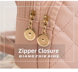 Detail of pink quilted leather mini backpack with dual gold circular metal zippers