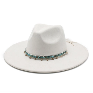 Detail of white fedora hat featuring bohemian beads and silver metal accents
